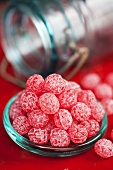 Raspberry sweets on lid of sweet jar