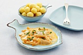 Fish fillet with onions and sour cream & paprika sauce