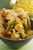 Chicken curry with flatbread (India)