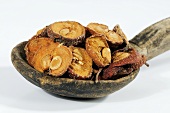 Dried haws (fruit of the hawthorn) on wooden spoon