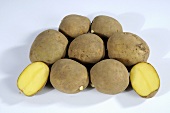 Several potatoes (variety 'Adretta'), whole and halved