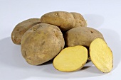Several potatoes (variety 'Ackersegen'), whole and halved