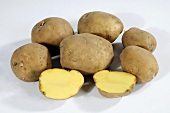 Several potatoes (variety 'Auralia'), whole and halved