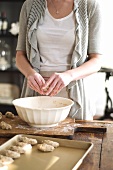 Woman shaping dough into crescents