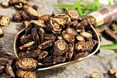 Dried Notopterygium root (Qiang Huo, China) in scoop