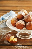 Doughnuts with icing sugar on cake stand