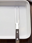 Carving fork on a plate
