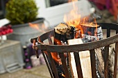 Feuerkorb mit brennenden Holzscheiten