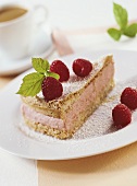 Piece of raspberry cake with icing sugar