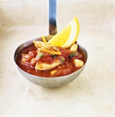 Tomato sauce with sherry and chicken on ladle