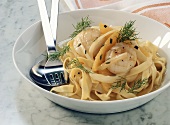 Ribbon pasta with scallops, fennel, oranges and dill