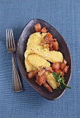 Breaded plaice fillets with tomatoes and bacon