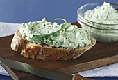Sour cream with rocket on slice of bread