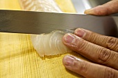 Cutting fish for sashimi