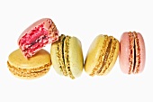 Several macarons, one partly eaten