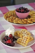 Cinnamon and vanilla waffles with berries and cream