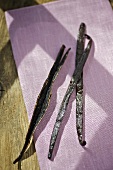 Vanilla pods on purple cloth