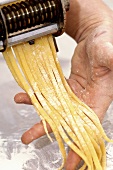 Home-made ribbon pasta on someone's hand
