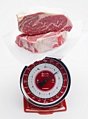 Beef steaks on kitchen scales