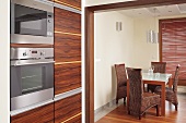 Kitchen with dining table and wicker chairs