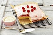 Cake with raspberry mousse topping, a piece removed