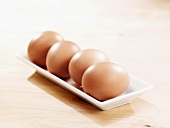 Brown eggs in a white dish