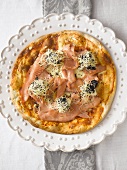 Pizza topped with smoked salmon, caviar and crème fraîche
