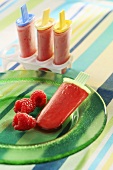 Home-made raspberry ice lollies