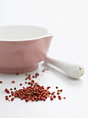 Pink peppercorns and pestle and mortar