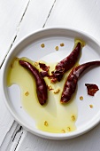 Three chili peppers marinated in oil