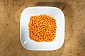 Red lentils in dish from above