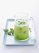 Honeydew melon cocktail with mint in a glass jug
