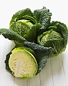 Savoy cabbages, whole and halved