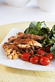 Chicken fillet with salad leaves, chick-peas and cherry tomatoes