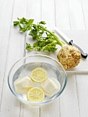 Peeled celeriac in lemon water