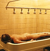 Woman lying on spa treatment table
