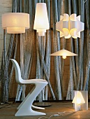 Various designer lamps and 50s shell chair in lighting designer's workshop