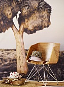 Fabric hats on wooden chair against photo wall mural of exotic tree