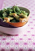 Gnocchi and salmon skewers with mixed salad leaves