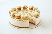 A cheesecake with profiteroles and white chocolate