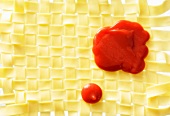 Ketchup on a mat of woven pasta