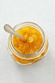 Orange marmalade in jar with spoon