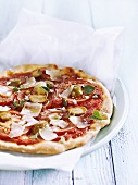 Tomato pizza with green olives and Parmesan