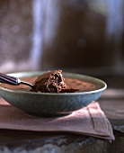 Chocolate mousse in a bowl with a spoon