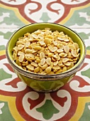 Dried soybeans in a green bowl