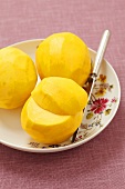 Three peeled mangos on a plate