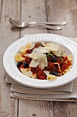 Farfalle with tomato sauce, black olives and Parmesan cheese
