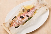 Triglia al cartoccio (red mullet with olives baked in parchment paper)