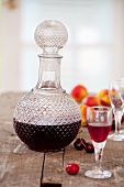Homemade cherry and apricot liqueur in a carafe and a glass