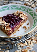 A slice of Linzer tart with lingonberry jam